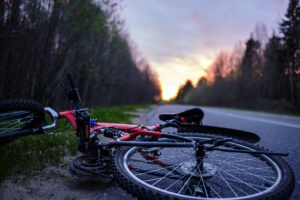 The bike lies on the roadway of the asphalt road in the lem.