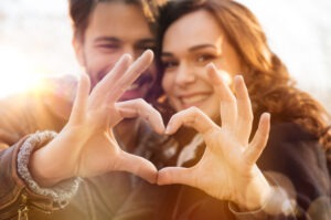 couple making heart shape with hands